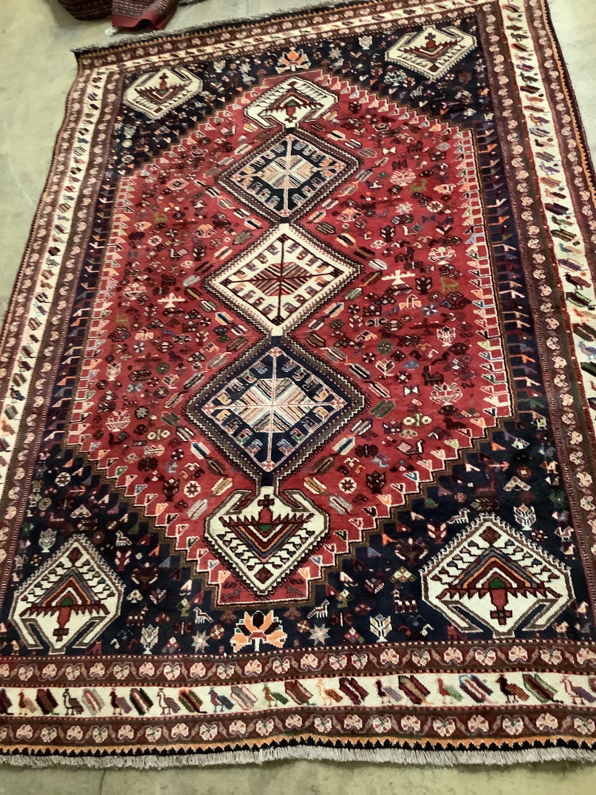 An Iranian Gashshghai red ground carpet, 291 x 208cm